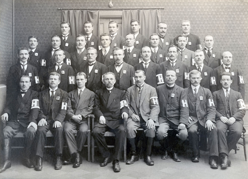After Tsar Nicholas II was overthrown in March 1917, policing in Finland was eventually taken over by local security corps. These groups generally carried an armband with the corps insignia. In Helsinki, a socialist public order commission was established in March. Members of the commission militia carried a red armband with a large H. Image: The People's Archives.